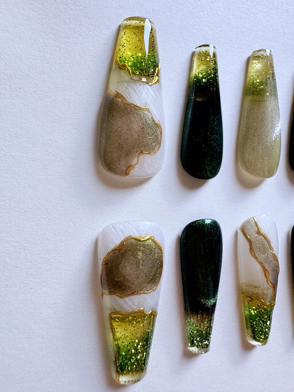 Emerald Pool Hand Drawn Elaborate Satin Gold Outline Emerald Cat Eye Flowing Sand Nail Art